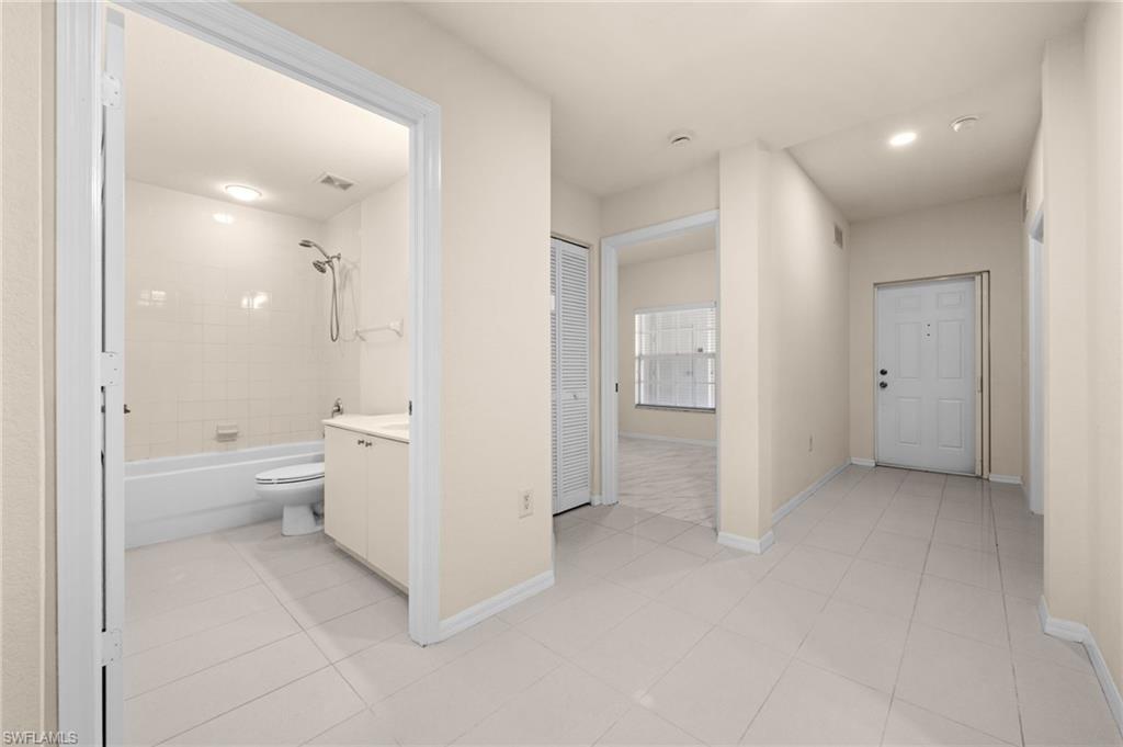 4520 Botanical Pl Circle, Unit 103 Naples, FL 34112 - Photo 12 of 19 Guest bath & foyer