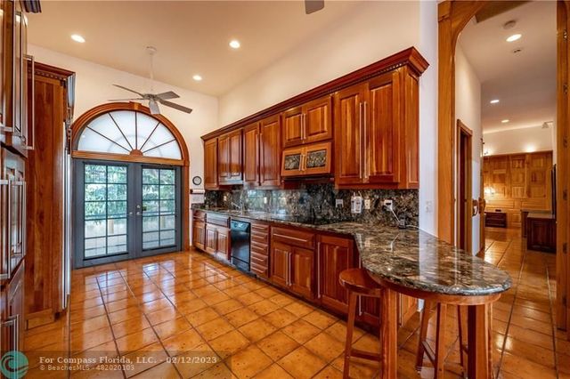 a kitchen with stainless steel appliances granite countertop a stove a sink and a dining table with granite countertop