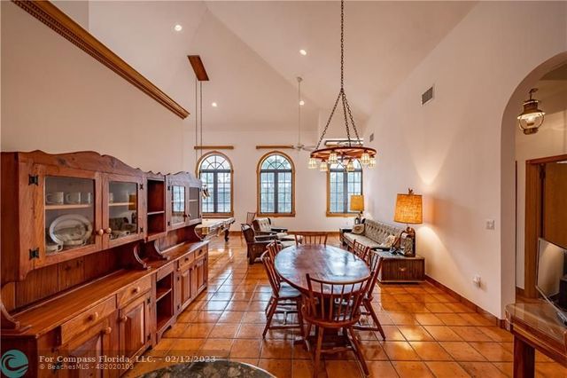 a dining room with furniture a chandelier and window