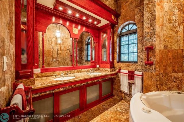 a bathroom with a bathtub and a double vanity sink