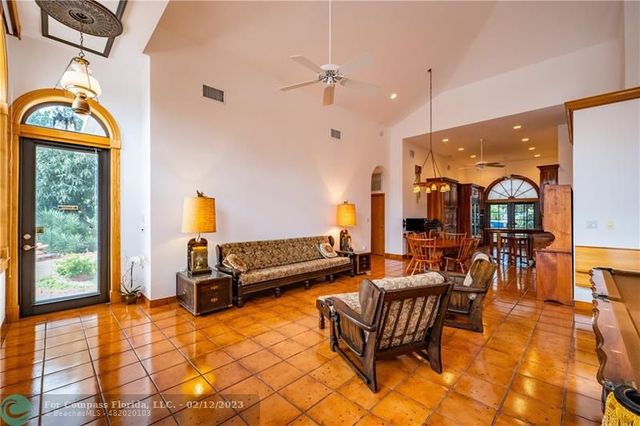 a living room with furniture a window and a chandelier