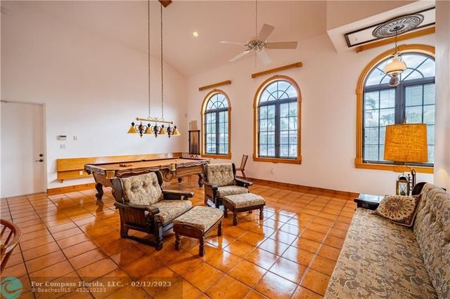 a living room with blue lights with furniture and a large window
