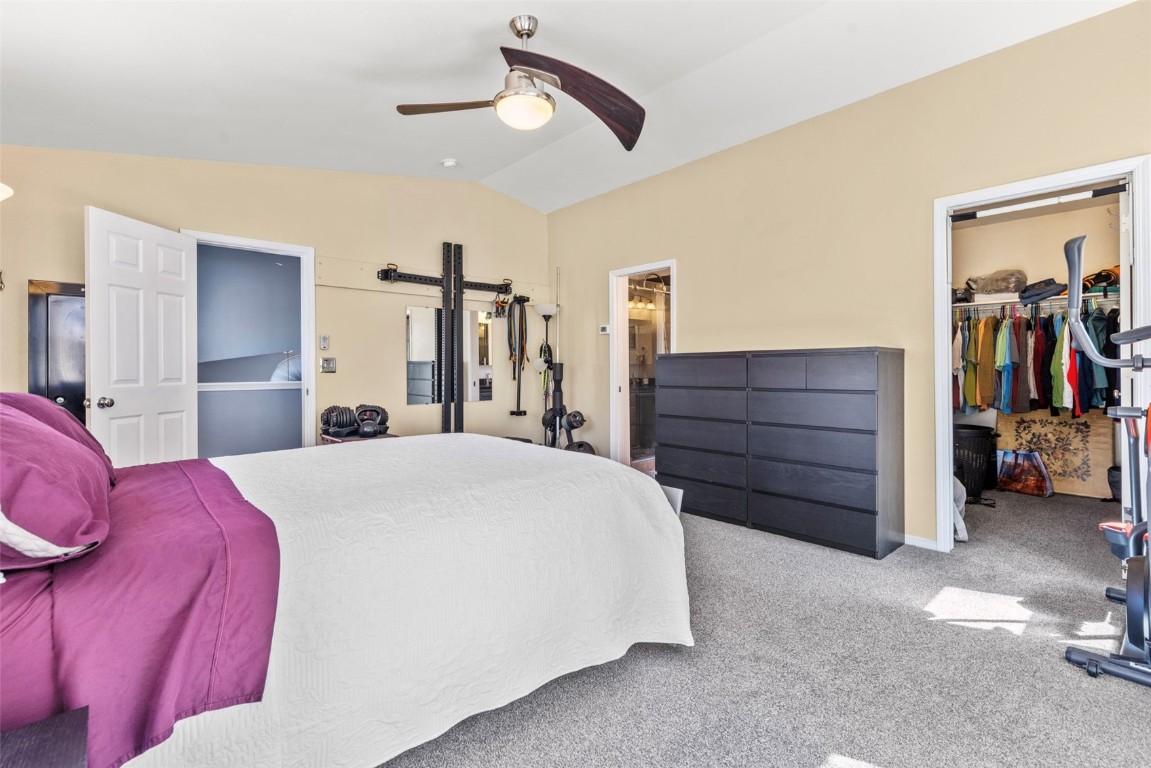 654 Alpine Road Dillon, CO 80435 - Photo 28 of 40 a spacious bedroom with a bed and a chandelier
