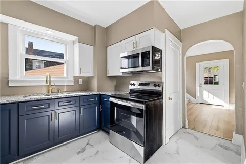a kitchen with stainless steel appliances granite countertop a stove and a microwave