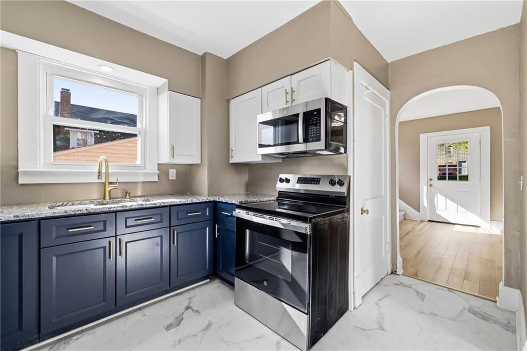 7 West Edison Avenue New Castle, PA 16101 - Photo 11 of 30 a kitchen with stainless steel appliances granite countertop a stove and a microwave