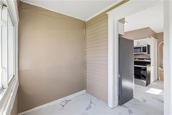 a view of an empty room with a window