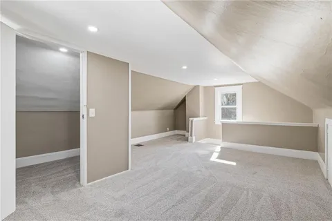 a bathroom with a granite countertop toilet sink and mirror