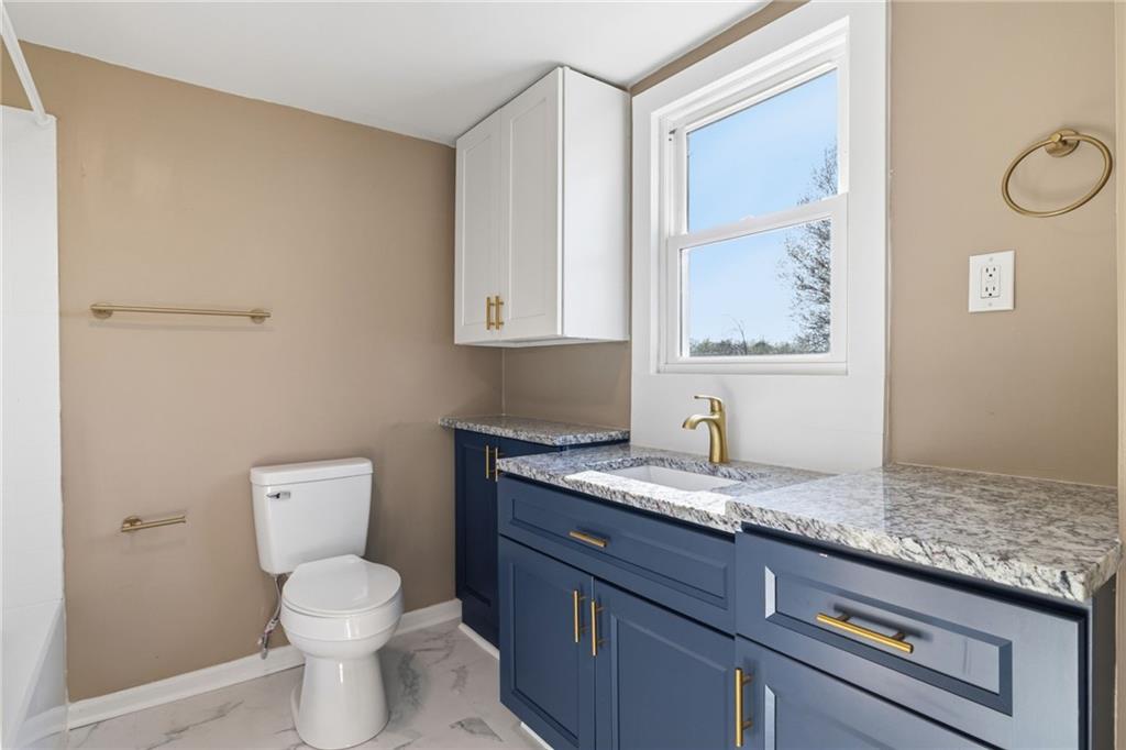 7 West Edison Avenue New Castle, PA 16101 - Photo 18 of 30 a bathroom with a granite countertop toilet sink and mirror