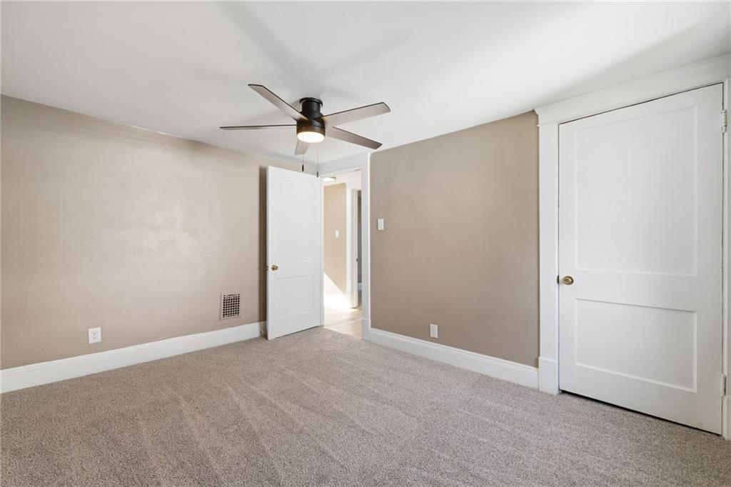 7 West Edison Avenue New Castle, PA 16101 - Photo 21 of 30 an empty room with a ceiling fan and a window