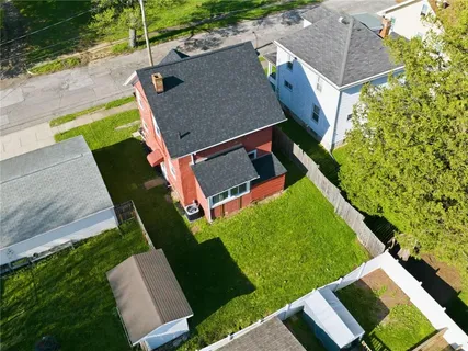 an aerial view of a house with a yard