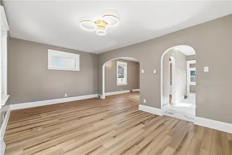 a view of a room with wooden floor and window