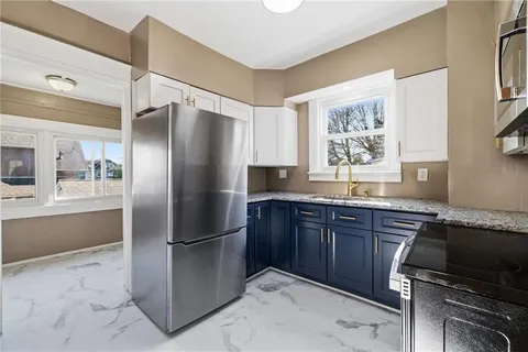 a kitchen with stainless steel appliances granite countertop a refrigerator and a sink