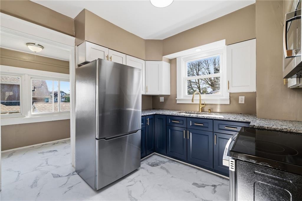 7 West Edison Avenue New Castle, PA 16101 - Photo 9 of 30 a kitchen with stainless steel appliances granite countertop a refrigerator and a sink