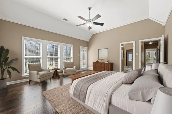 a spacious bedroom with a large bed and a large window