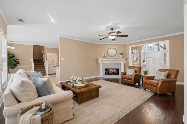 a living room with furniture a fireplace and a large mirror