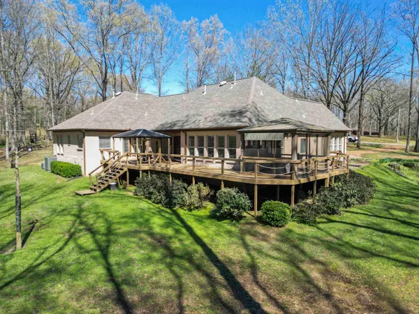 a aerial view of a house with a yard table and chairs
