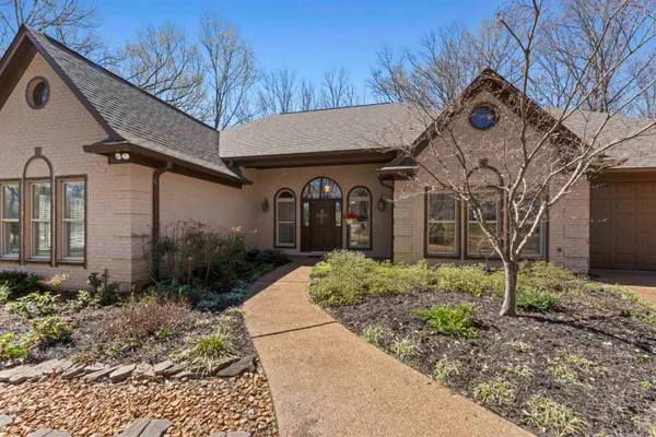 a front view of a house with garden