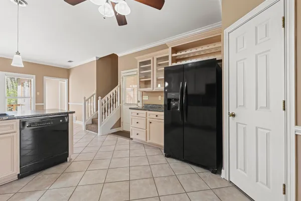 a kitchen with a refrigerator and a stove top oven