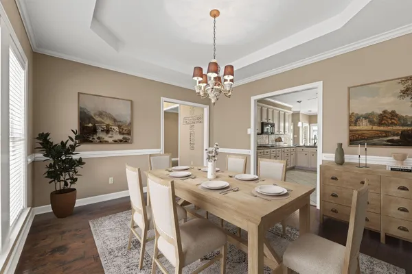 a view of a dining room with furniture and chandelier