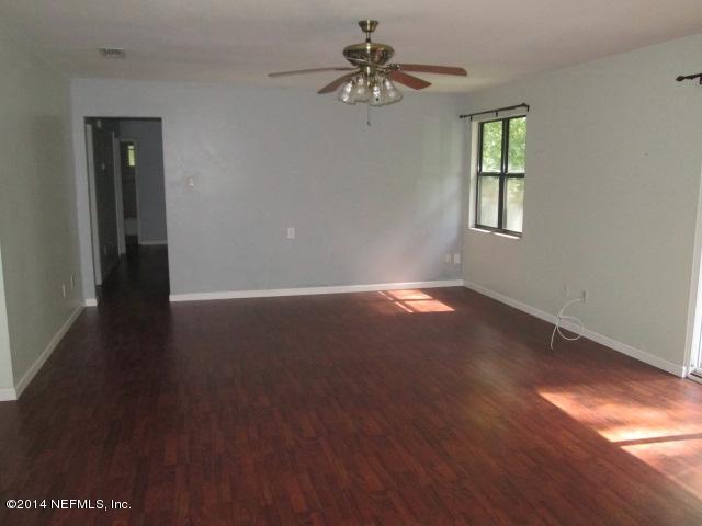 4123 Cedar Road Orange Park, FL 32065 - Photo 3 of 15 wooden floor in an empty room with a window