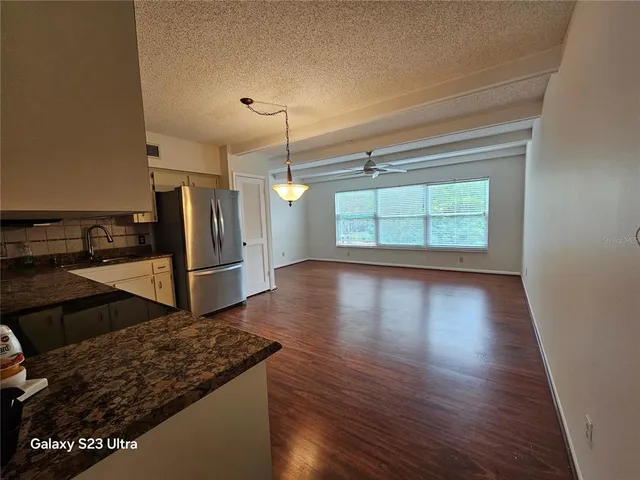 a bathroom with a granite countertop sink toilet mirror and shower