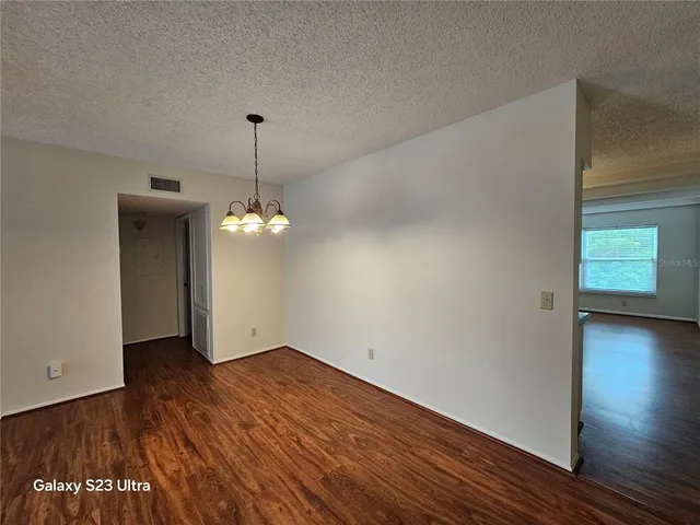 a view of kitchen and hall with wooden floor