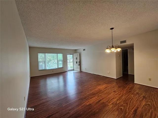 a kitchen with stainless steel appliances granite countertop a stove and a wooden floors