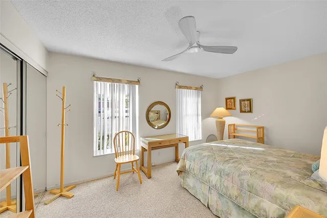 a bedroom with a bed a mirror and a window