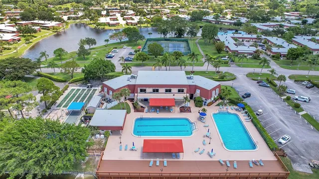 an aerial view of swimming pool patio and lake view