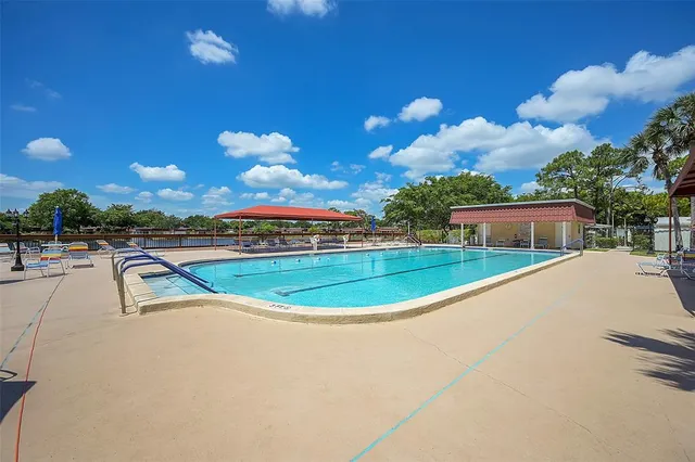 a view of a swimming pool with a yard