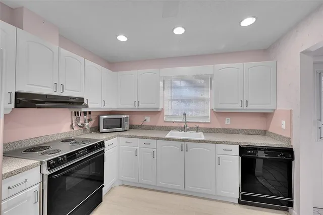 a utility room with sink dryer and washer