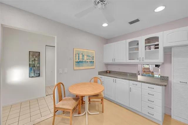 a spacious bathroom with a granite countertop sink a toilet a mirror and a window