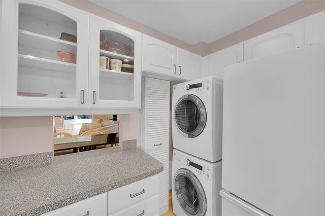 a utility room with sink dryer and washer
