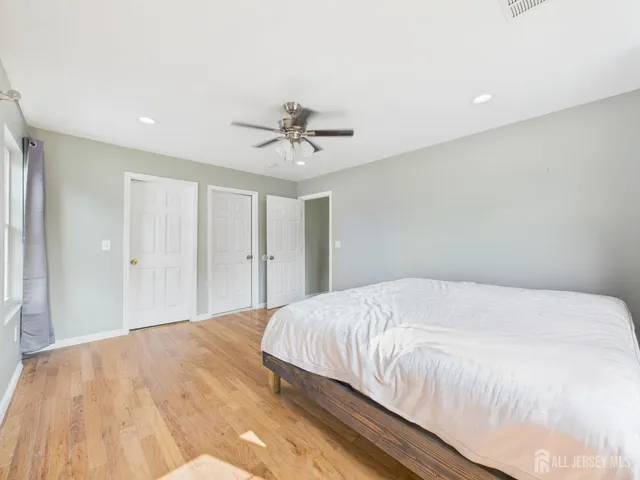 a bedroom with a large bed and a chandelier