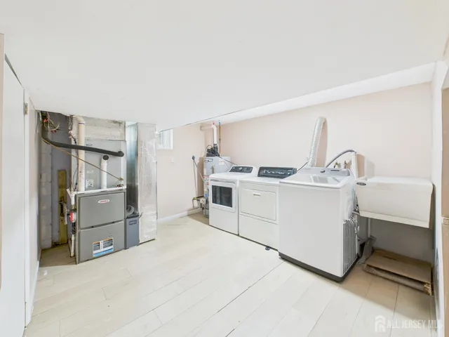 a kitchen with white cabinets and refrigerator