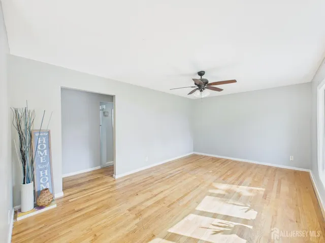 a view of a room with a ceiling fan