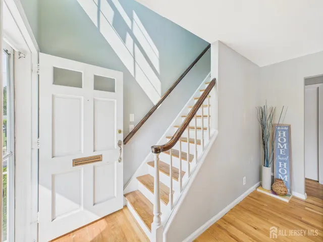 a view of entryway with wooden floor and door