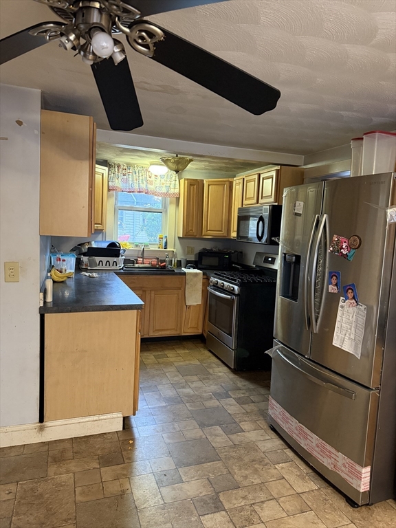 102 Weare Street Lawrence, MA 01843 - Photo 12 of 27 a kitchen with stainless steel appliances granite countertop a sink a stove and a refrigerator