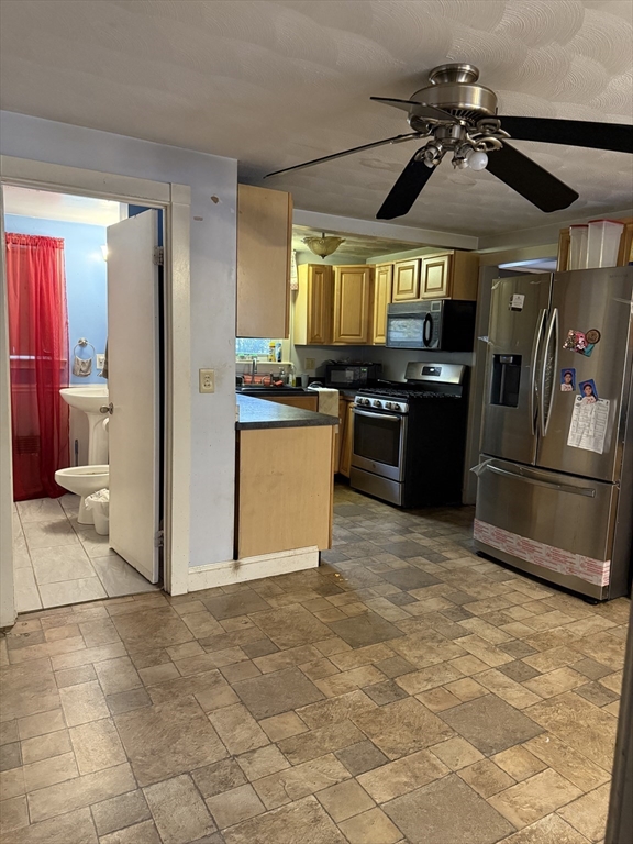 102 Weare Street Lawrence, MA 01843 - Photo 14 of 27 a kitchen with granite countertop a refrigerator and a stove top oven