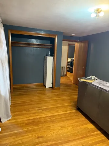 a view of room with wooden floor