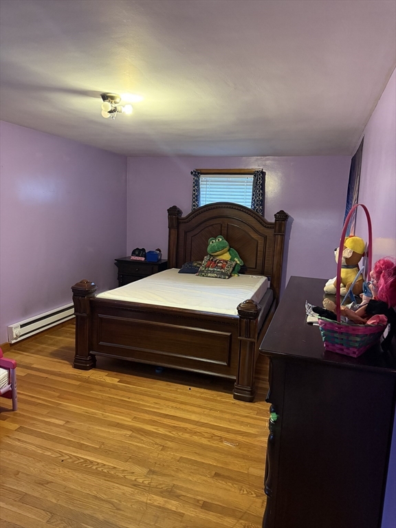 102 Weare Street Lawrence, MA 01843 - Photo 21 of 27 a bedroom with a bed and a dresser