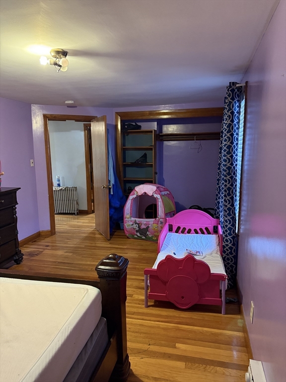 102 Weare Street Lawrence, MA 01843 - Photo 22 of 27 a bedroom with a bed and a mirror