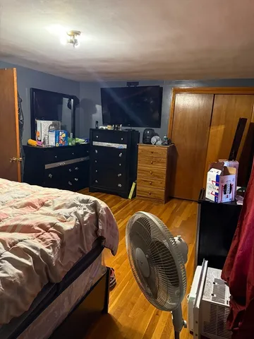 a bedroom with a bed and dresser