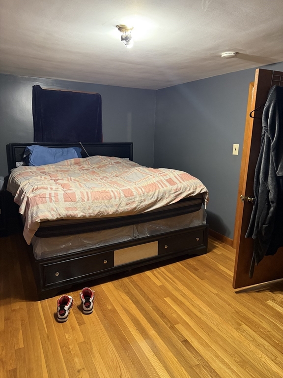 102 Weare Street Lawrence, MA 01843 - Photo 24 of 27 a bedroom with a bed and dresser