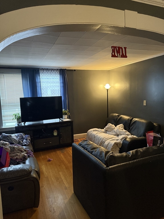 102 Weare Street Lawrence, MA 01843 - Photo 9 of 27 a bedroom with furniture and a flat screen tv