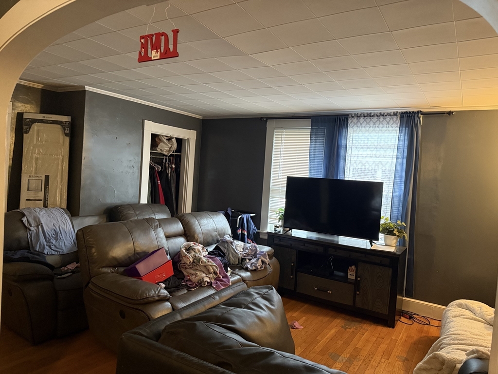 102 Weare Street Lawrence, MA 01843 - Photo 10 of 27 a living room with furniture and a flat screen tv
