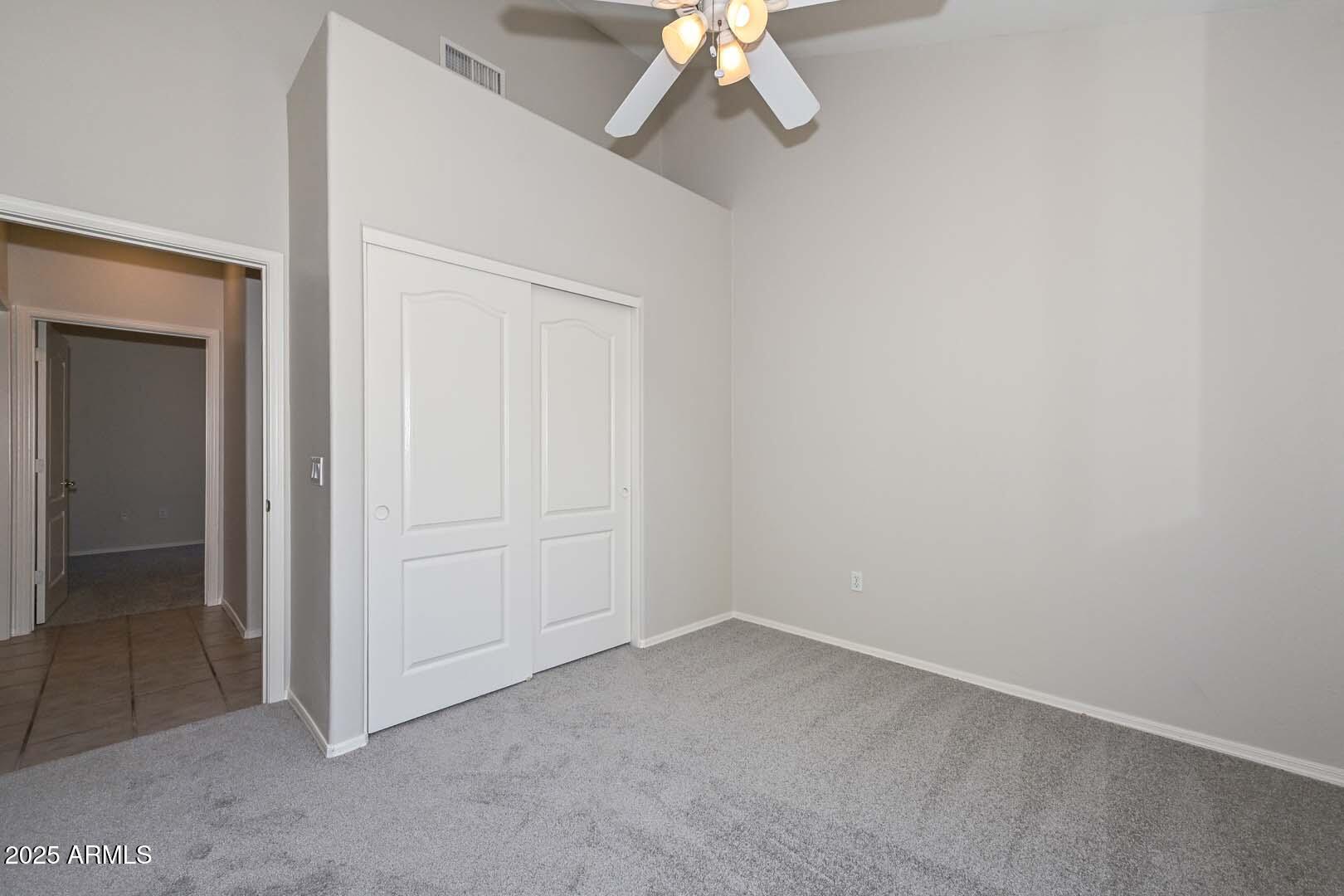 7101 West Beardsley Road, Unit 1104 Glendale, AZ 85308 - Photo 20 of 40 an empty room with a chandelier fan