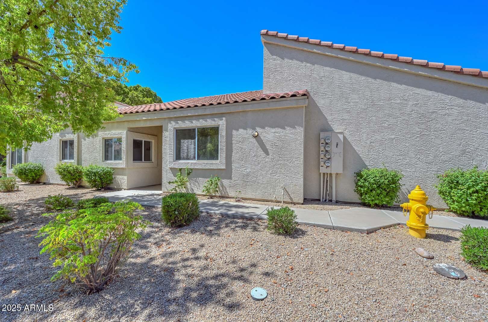 7101 West Beardsley Road, Unit 1104 Glendale, AZ 85308 - Photo 2 of 40 a front view of a house with garden