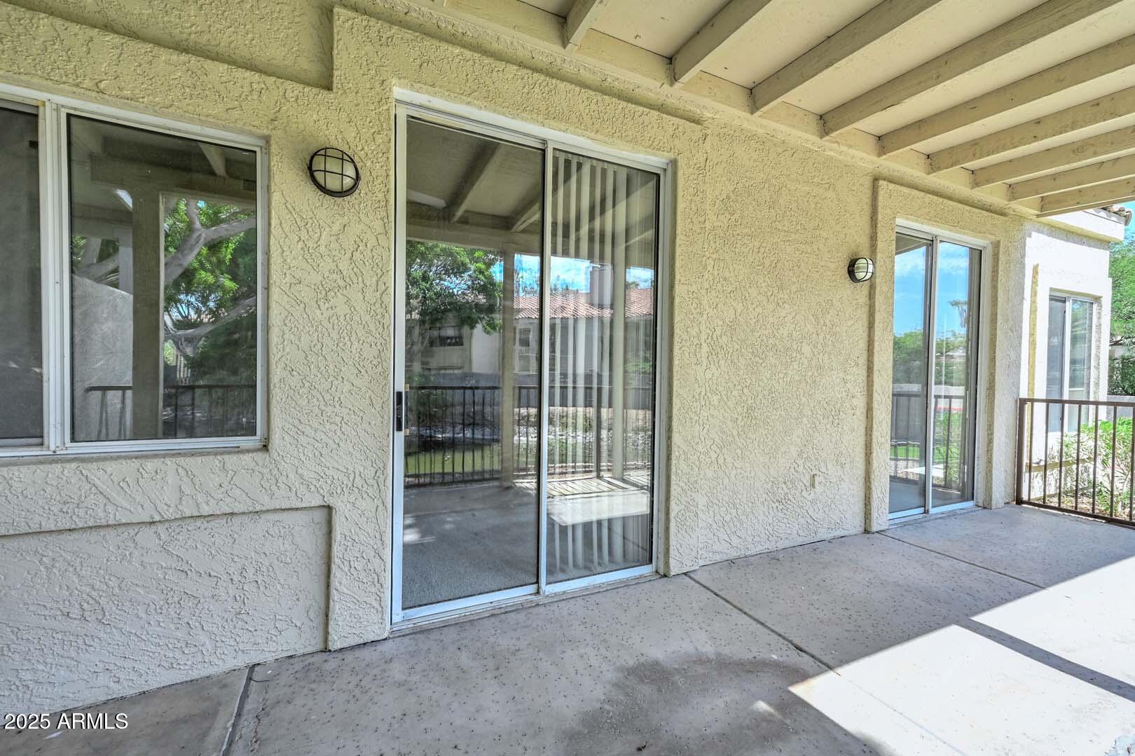 7101 West Beardsley Road, Unit 1104 Glendale, AZ 85308 - Photo 25 of 40 a view of a porch with a floor to ceiling window