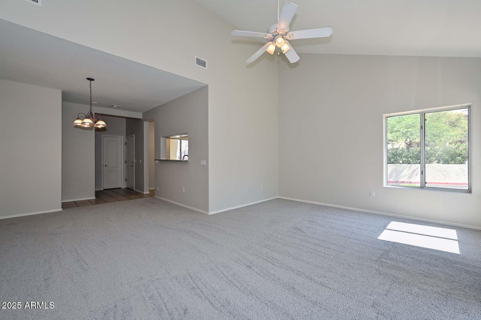 7101 West Beardsley Road, Unit 1104 Glendale, AZ 85308 - Photo 3 of 40 an empty room with windows and ceiling fan
